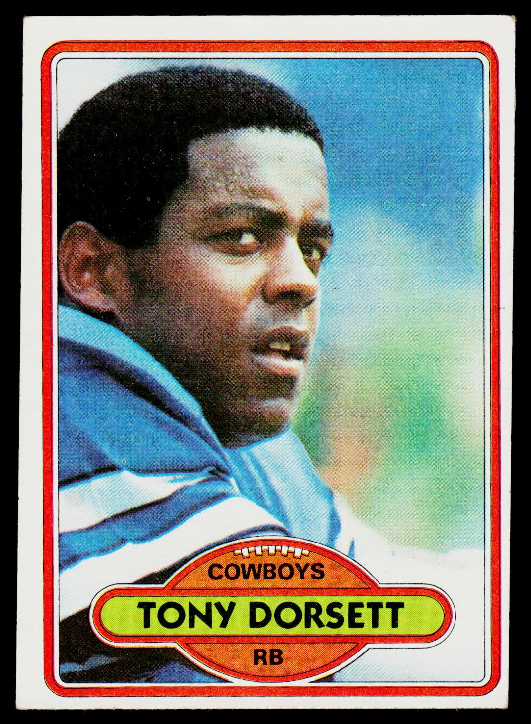 A vintage football trading card featuring a portrait of Tony Dorsett, Cowboys RB. The card has a red border, a blue and green background, and a yellow nameplate at the bottom.