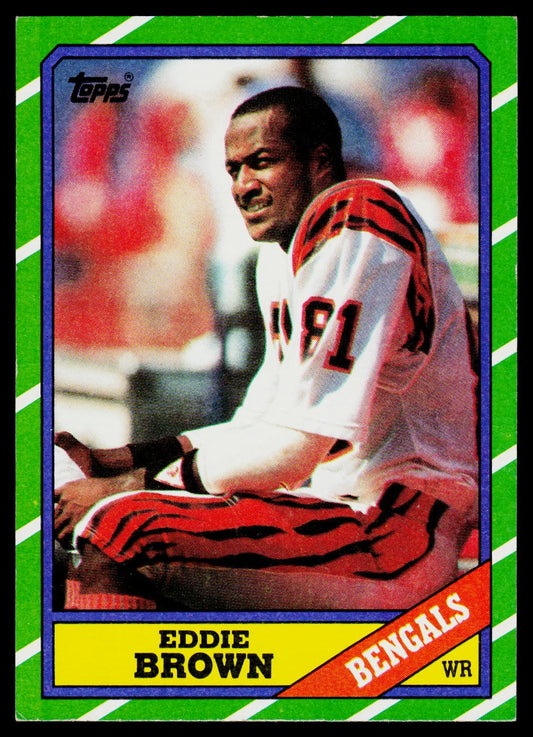A vintage Topps Eddie Brown Bengals football trading card, showing a seated player in a white and red uniform against a green striped border.