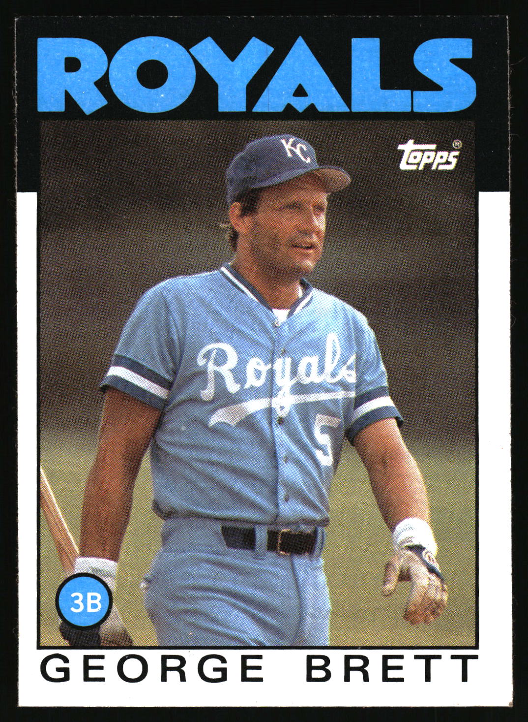 A vintage Topps baseball trading card featuring George Brett in a Kansas City Royals light blue jersey and cap, with the word ROYALS at the top and the Topps logo in the upper right.