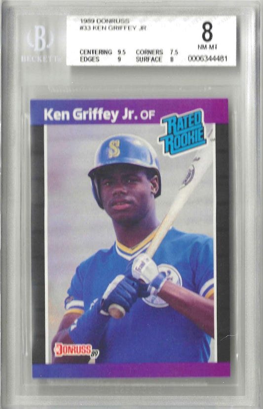Vintage trading card with 'Rated Rookie' text featuring a photo of Ken Griffey Jr holding a baseball bat. Grade 8 NM MT