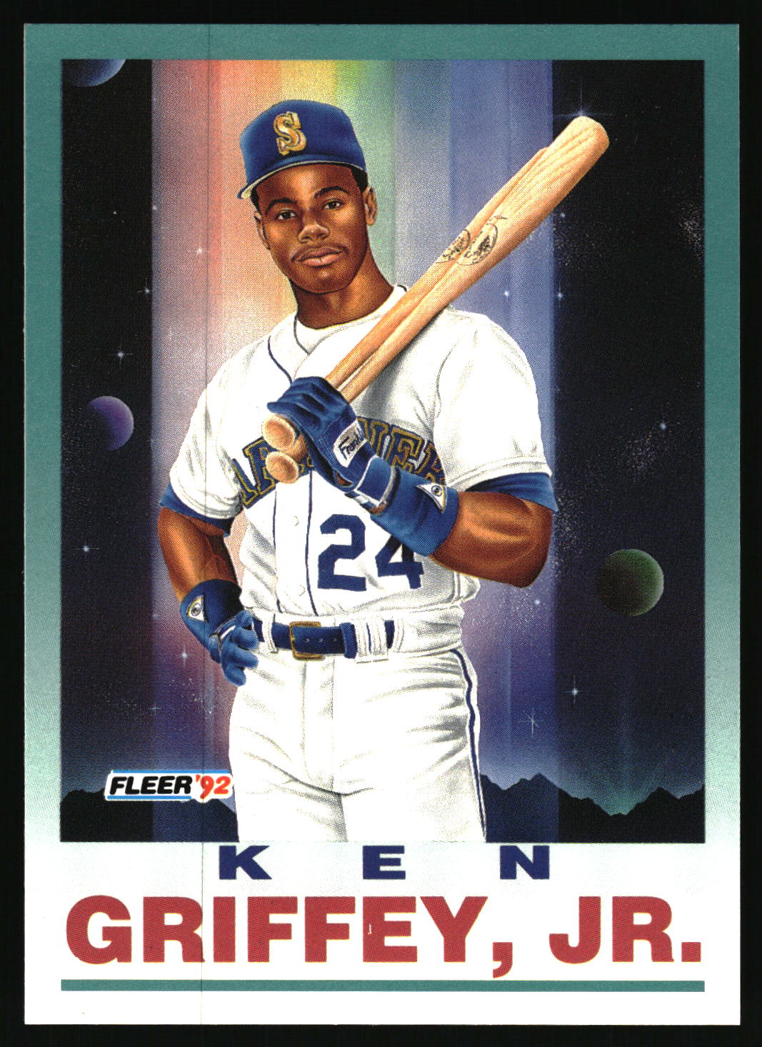 A Fleer '92 baseball trading card featuring Ken Griffey, Jr. in a white Seattle Mariners uniform, holding a bat against a space-themed background with planets and rainbow light streaks.