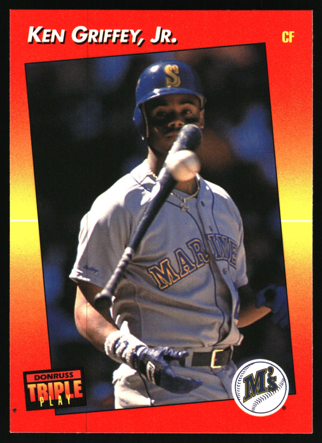 A vintage baseball trading card featuring Ken Griffey, Jr. in a gray Seattle Mariners uniform, holding a bat.
