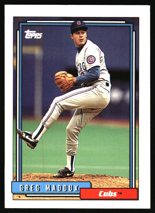 A vintage Topps baseball trading card featuring pitcher Greg Maddux in a Chicago Cubs uniform, shown with a black border and card details including the Topps logo and Cubs nameplate.