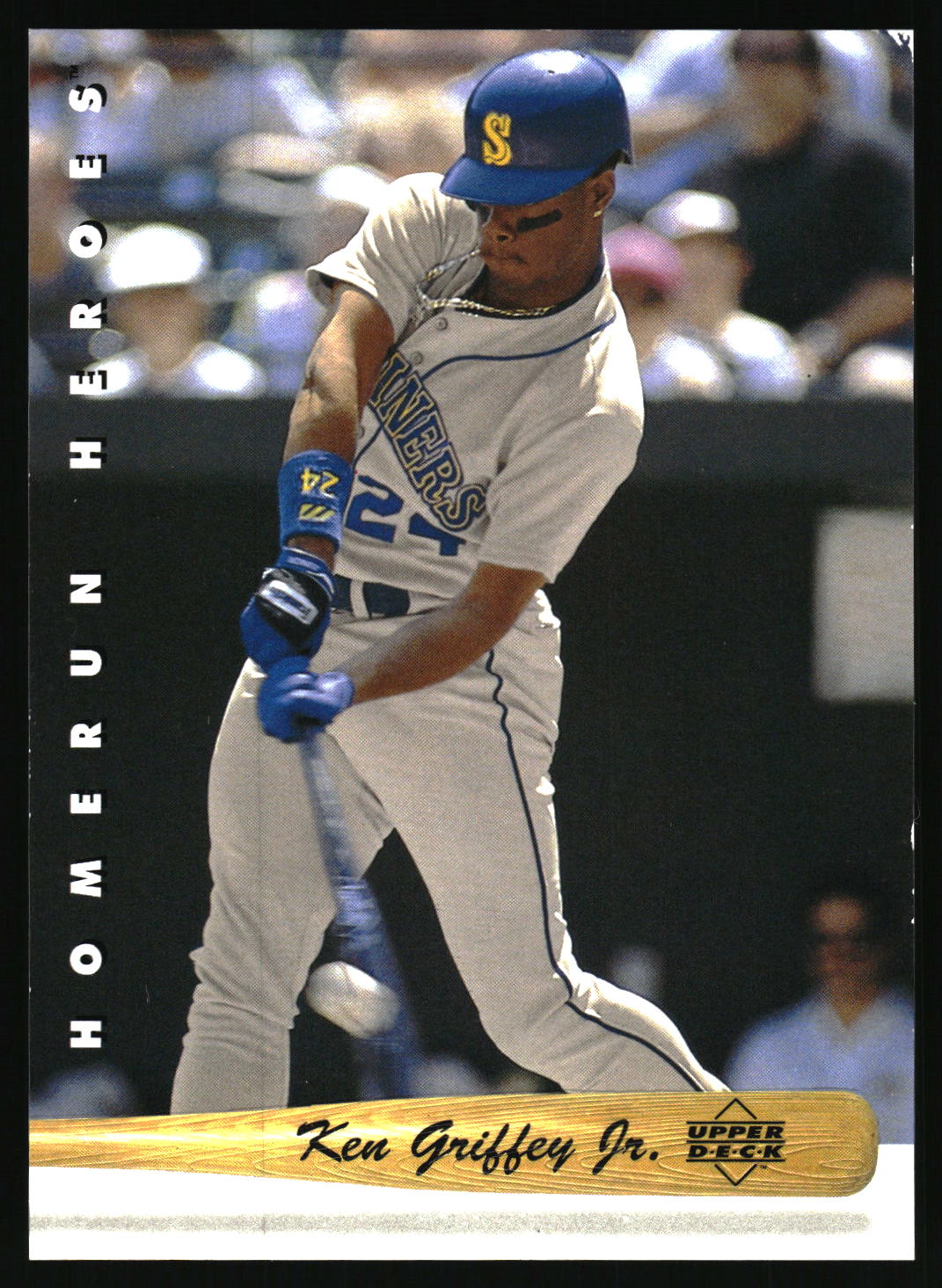 A baseball trading card featuring Ken Griffey Jr. in a batting stance, wearing a gray Seattle Mariners uniform and blue helmet.