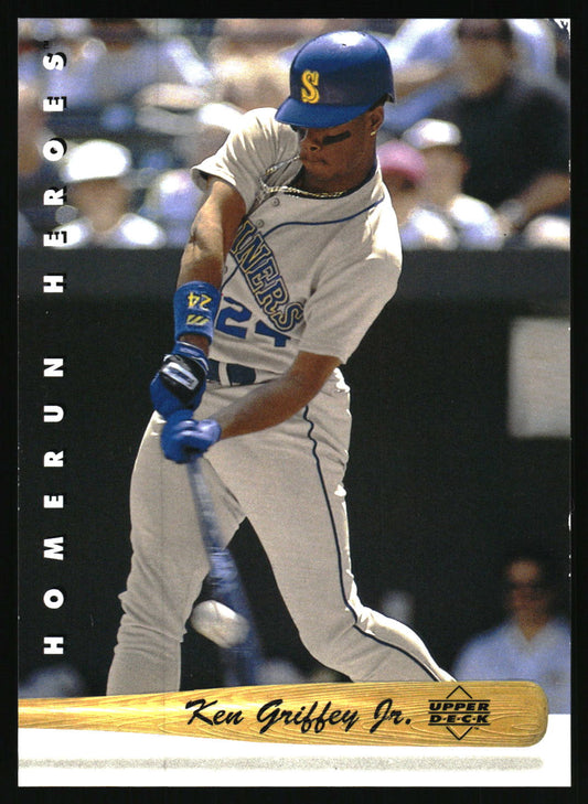 A baseball trading card featuring Ken Griffey Jr. in a batting stance, wearing a gray Seattle Mariners uniform and blue helmet.