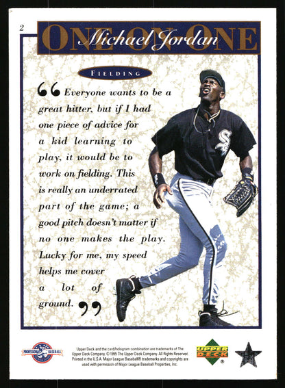 A vintage Michael Jordan trading card  featuring a portrait of the player in a Chicago White Sox uniform and a quote about fielding. The card has a textured cream background with a blue border and 'ONE ON ONE Michael Jordan' at the top, plus Upper Deck branding.