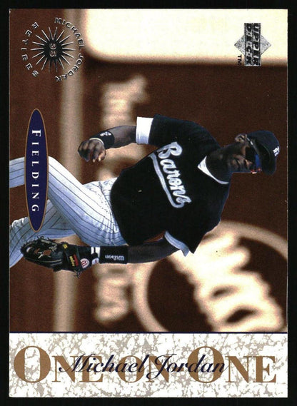 A baseball trading card featuring Michael Jordan in a black and white Barons jersey, with a textured beige vertical banner on the right reading 'ONE Michael JORDAN ONE' and a 'Fielding' label at the bottom.