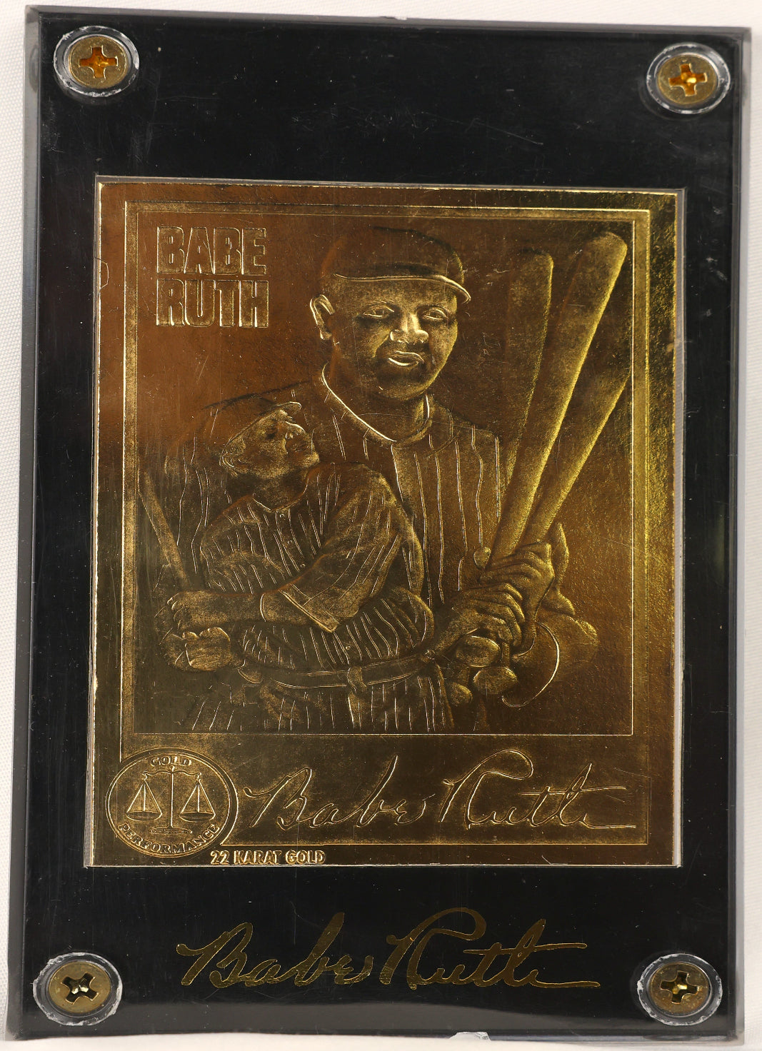 A square black plaque featuring a raised gold-toned portrait of Babe Ruth holding a bat, with his signature and the text 'Babe Ruth' on the plaque.