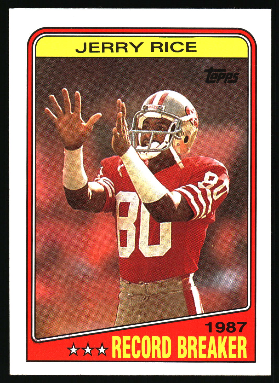 A vintage 1987 Topps Jerry Rice football trading card, featuring a photo of Rice in a red San Francisco 49ers jersey with the number 80, set against a red background with a yellow border.