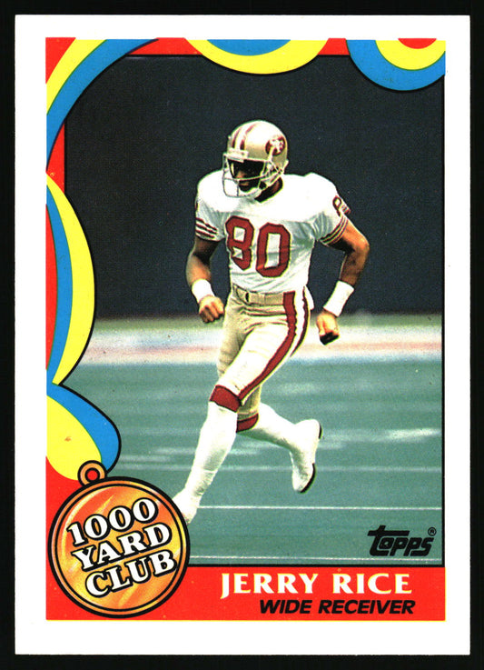 A vintage Topps football trading card featuring Jerry Rice, wide receiver for the San Francisco 49ers, wearing a white and red uniform with the number 80. The card has a colorful abstract border and a '1000 Yard Club' badge.