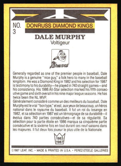 A vintage baseball trading card back featuring Dale Murphy, with a yellow border, black header, white text, and a small team logo. The card includes biographical text in English and French and is photographed against a light neutral background.