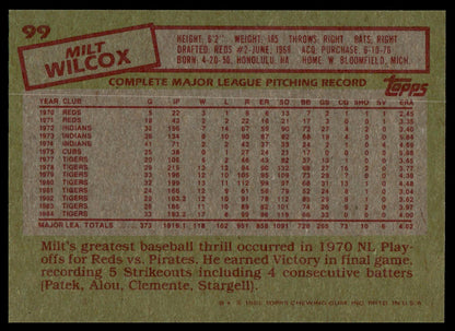 The back of a vintage 1985 Topps baseball card for pitcher Milt Wilcox, showing his career statistics and height, weight, and birth details in red text on a tan background.
