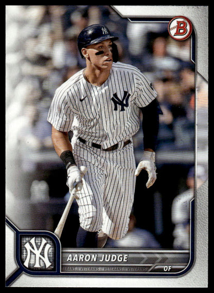 A baseball trading card featuring Aaron Judge in a New York Yankees pinstripe uniform, with the Yankees logo, a Nike swoosh, and a red circular 'B' mark visible on the card.