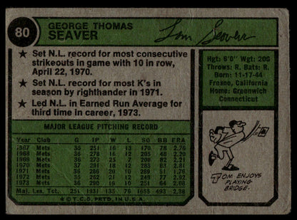 A vintage baseball trading card back featuring George Seaver, with green and beige panels, text, player statistics, a small cartoon, and a signature.