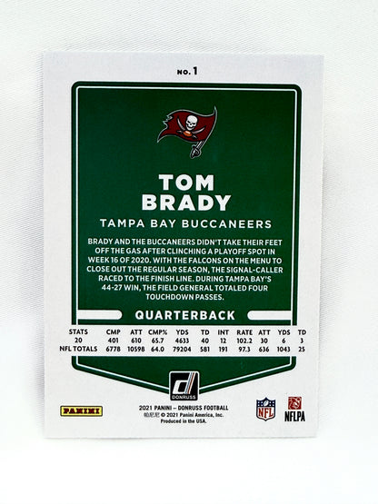 A collectible 2021 Panini Tom Brady Tampa Bay Buccaneers trading card, featuring a dark green and white design with player statistics and the Buccaneers logo.