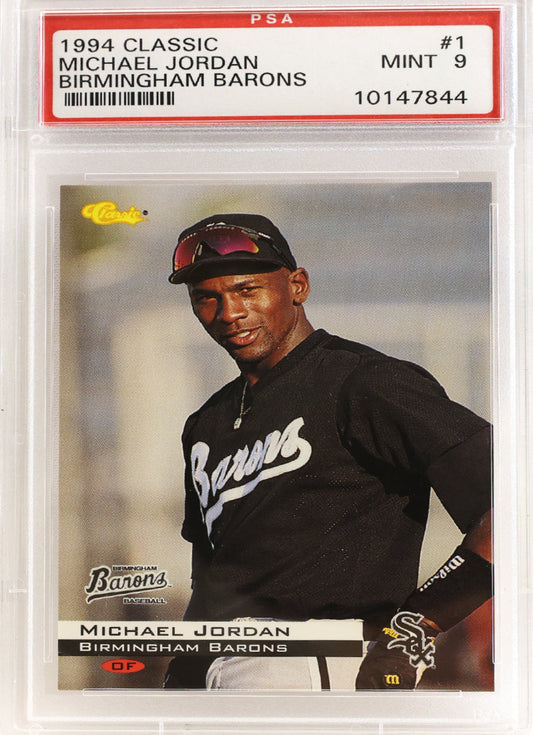 A PSA graded 1994 Michael Jordan baseball card, #1 from the Birmingham Barons, sealed in a clear PSA holder. The card features Jordan in a black uniform with 'Barons' written on it, and the PSA grading label is visible at the top MINT 9.