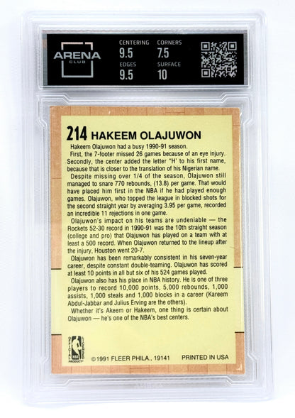 A Fleer  basketball card of Hakeem Olajuwon, graded 8 by Arena Sports, sealed in a clear protective plastic holder.