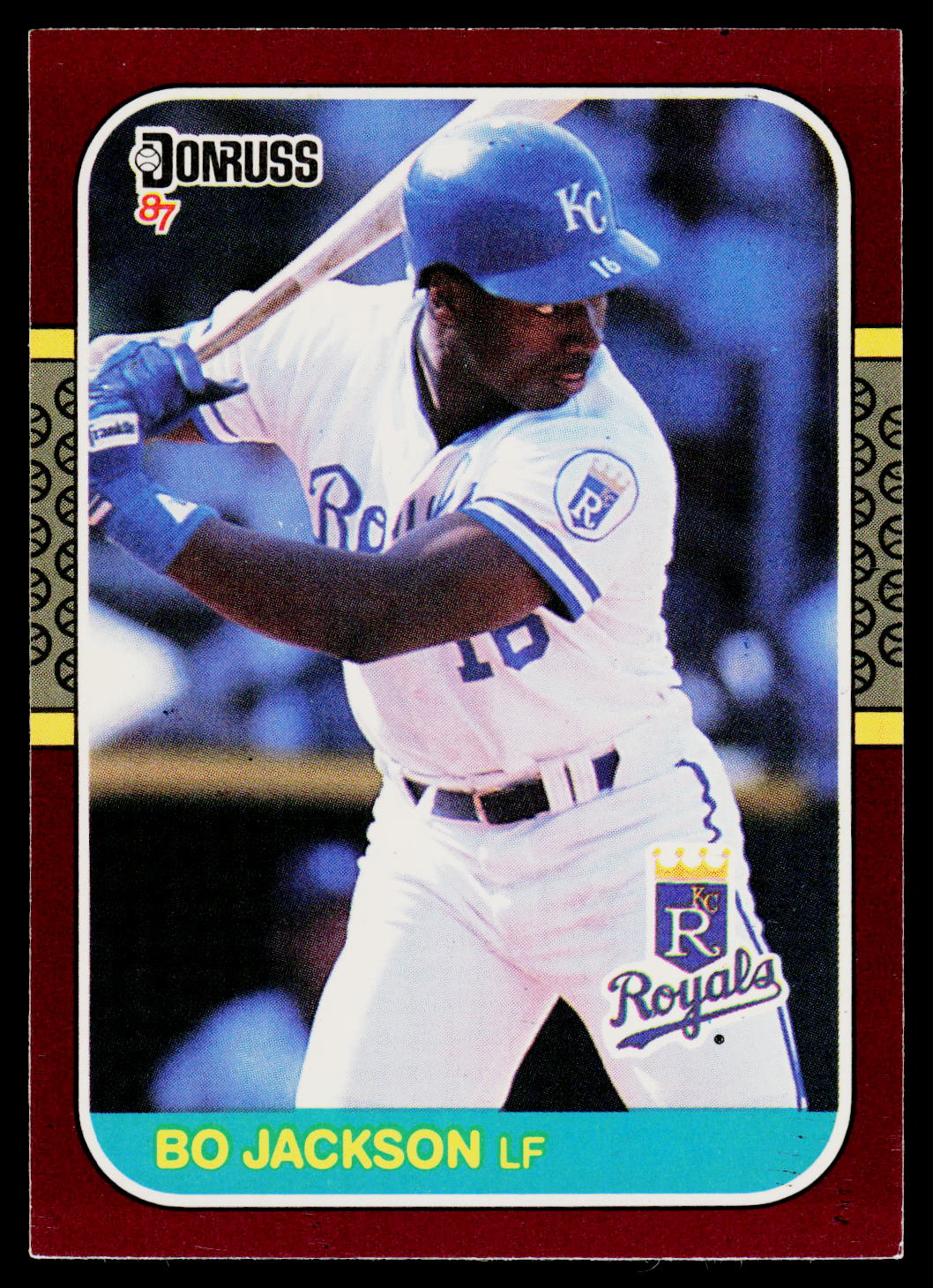 A vintage 1987 Donruss baseball trading card featuring Bo Jackson in a Kansas City Royals uniform, shown against a dark red card border with yellow and black decorative side panels.