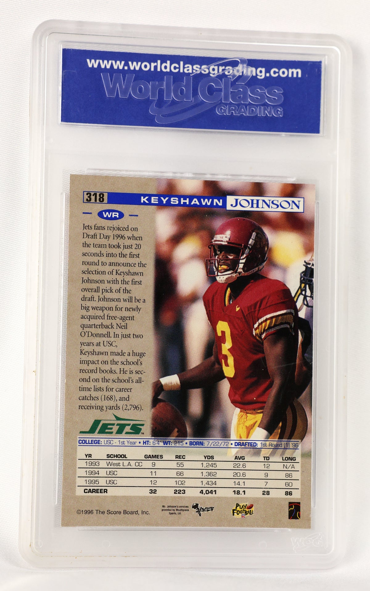 A 1996 Keyshawn Johnson NFL trading card graded and encapsulated in a clear plastic holder by World Class Grading. The card features a photo of Johnson in a red football uniform with the number 3, and includes a blue header with player details and a statistics table at the bottom.