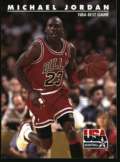 A Michael Jordan basketball trading card featuring him in a red Chicago Bulls jersey number 23, dribbling a basketball on the court, with the text 'MICHAEL JORDAN' at the top and 'USA BASKETBALL' in the lower right corner.
