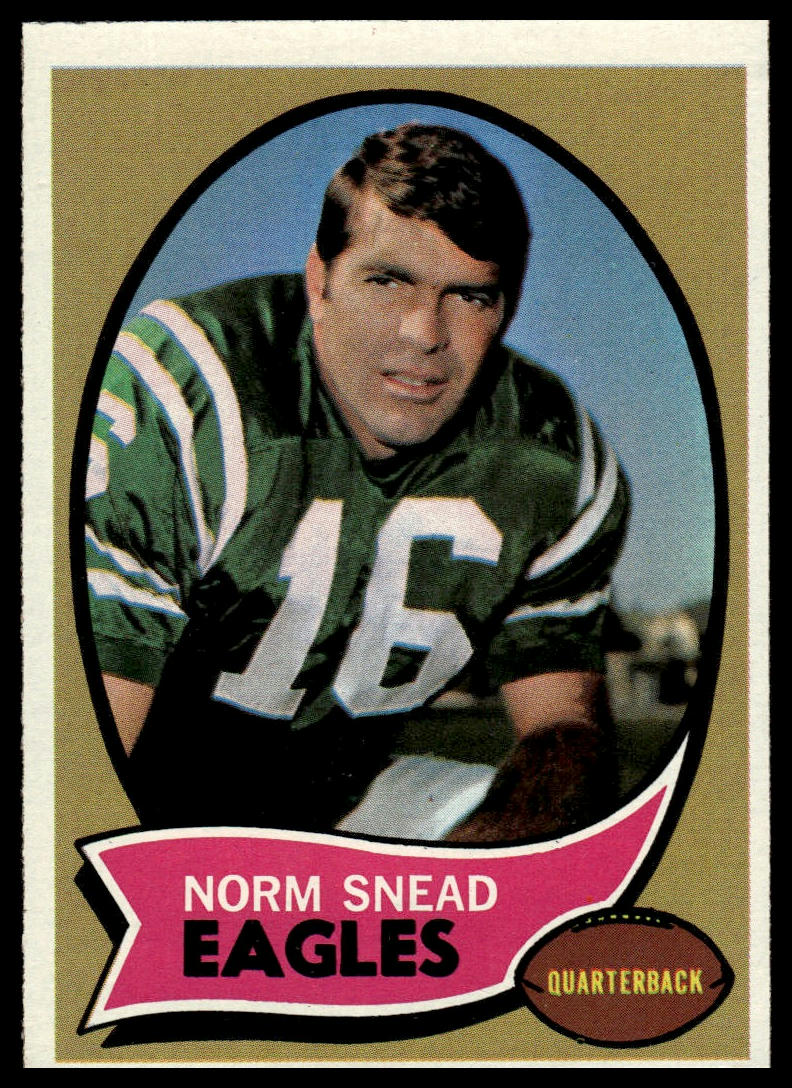 A vintage football trading card featuring a portrait of Norm Snead, an Eagles quarterback, wearing a green jersey with the number 16. The card has a tan background with a pink banner at the bottom containing his name and team.