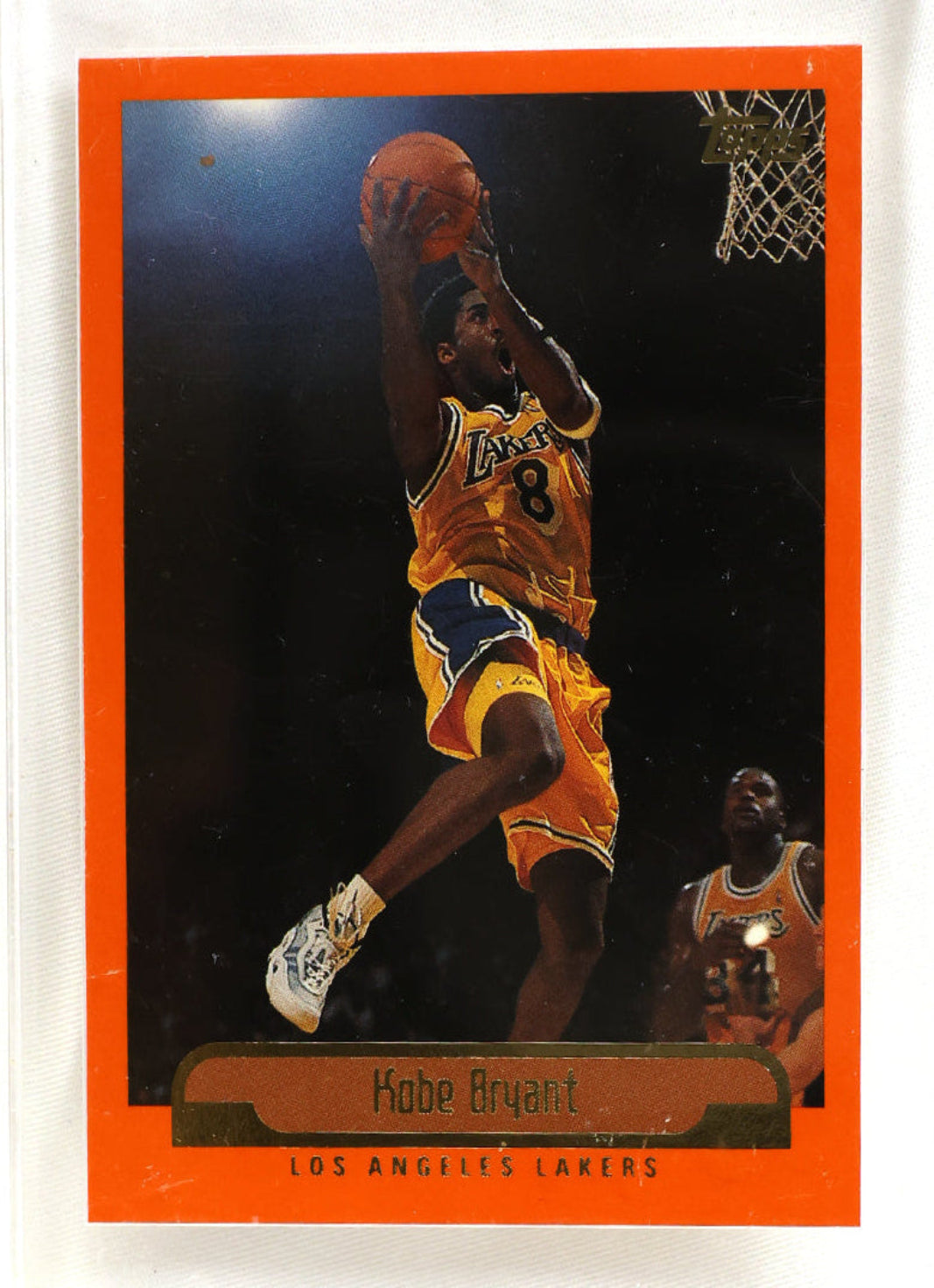 A vintage Kobe Bryant Los Angeles Lakers basketball trading card with an orange border, mounted in a clear plastic protective case with four corner screws visible against a white background.
