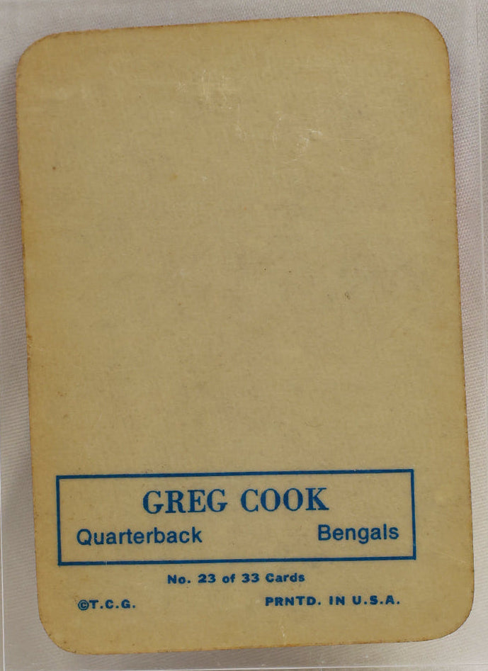 A vintage football trading card featuring Greg Cook of the Baltimore Bengals, displayed inside a clear protective plastic case on a light background.