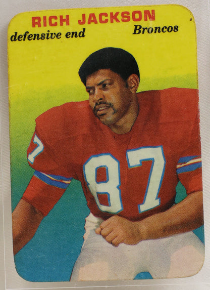 A vintage Rich Jackson football trading card, showing him in a red Broncos jersey with the number 87, housed in a clear protective plastic sleeve.