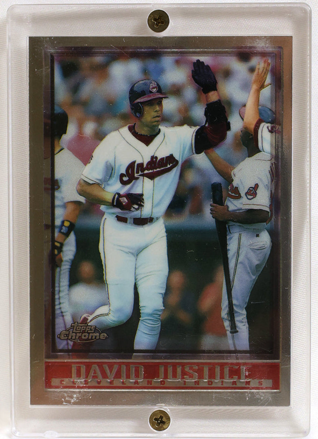 A collectible baseball trading card of David Justice in a clear plastic protective case with two metal screw fasteners, set against a plain white background.
