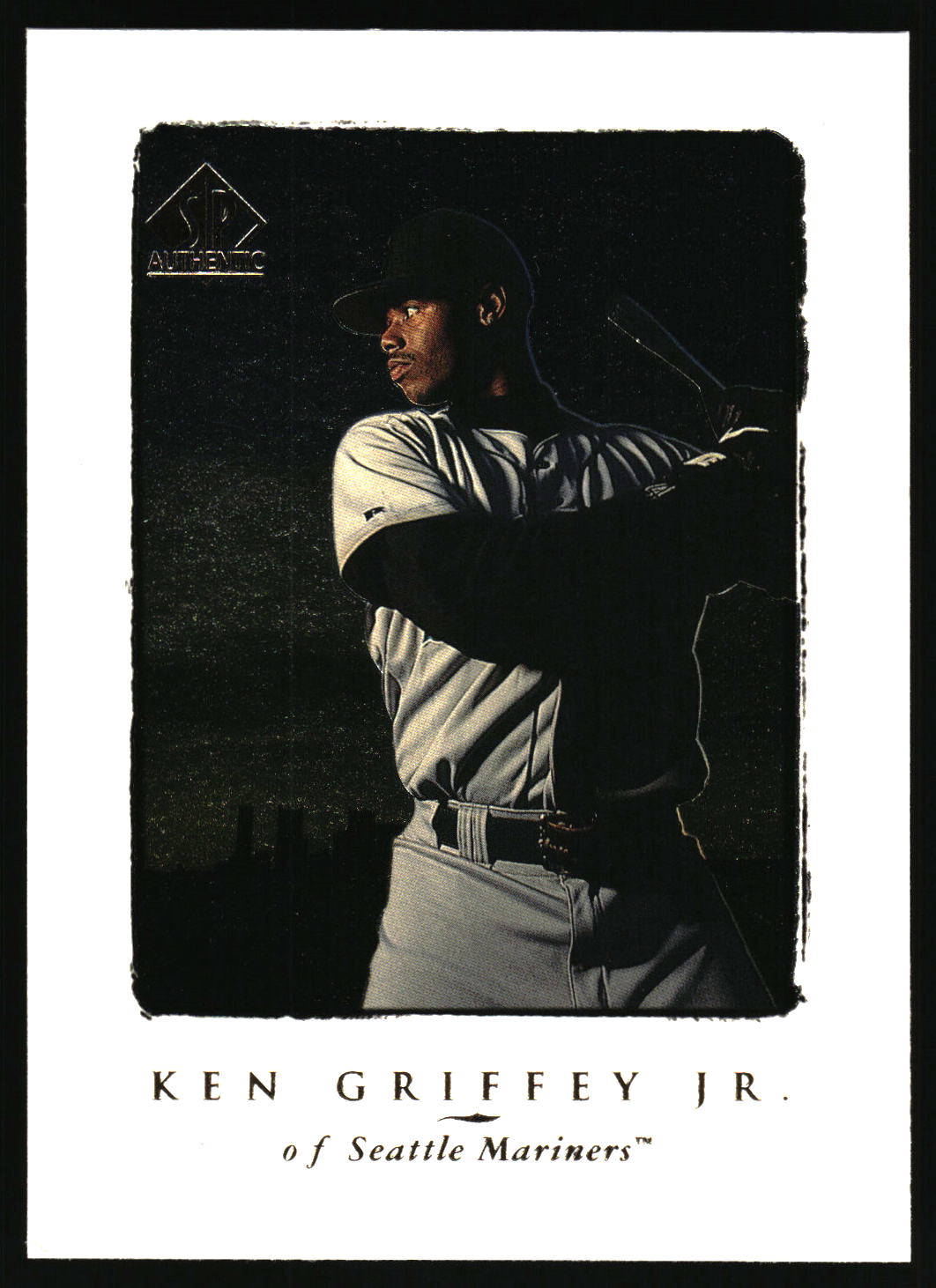 A baseball trading card featuring Ken Griffey Jr. in a Seattle Mariners uniform, with a black-and-white border and text at the bottom reading 'KEN GRIFFEY JR.