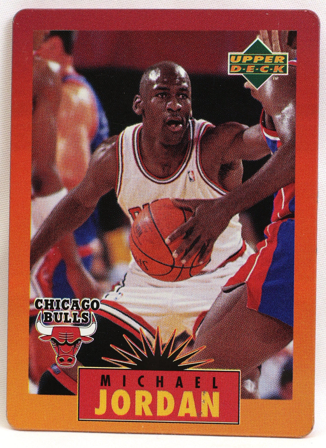 A vintage 1996 Upper Deck Michael Jordan Chicago Bulls basketball trading card, featuring a red border and a photo of Jordan in his white Bulls uniform.