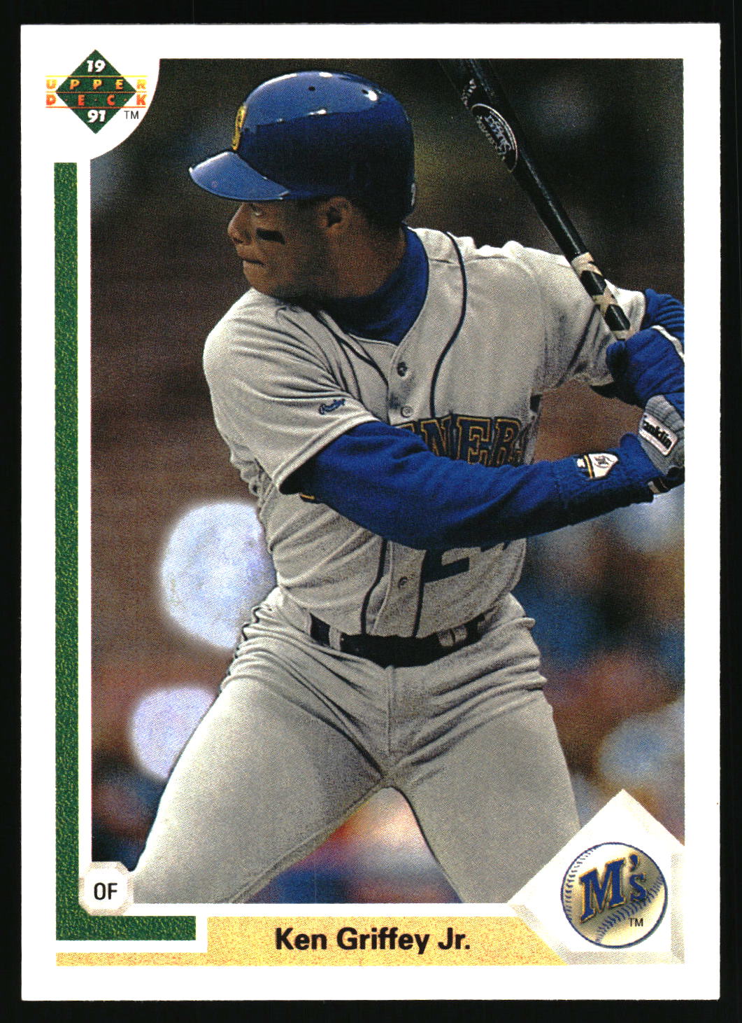A vintage baseball trading card featuring Ken Griffey Jr. in a batting stance, wearing a gray and blue  uniform, with a white border and team logo details.