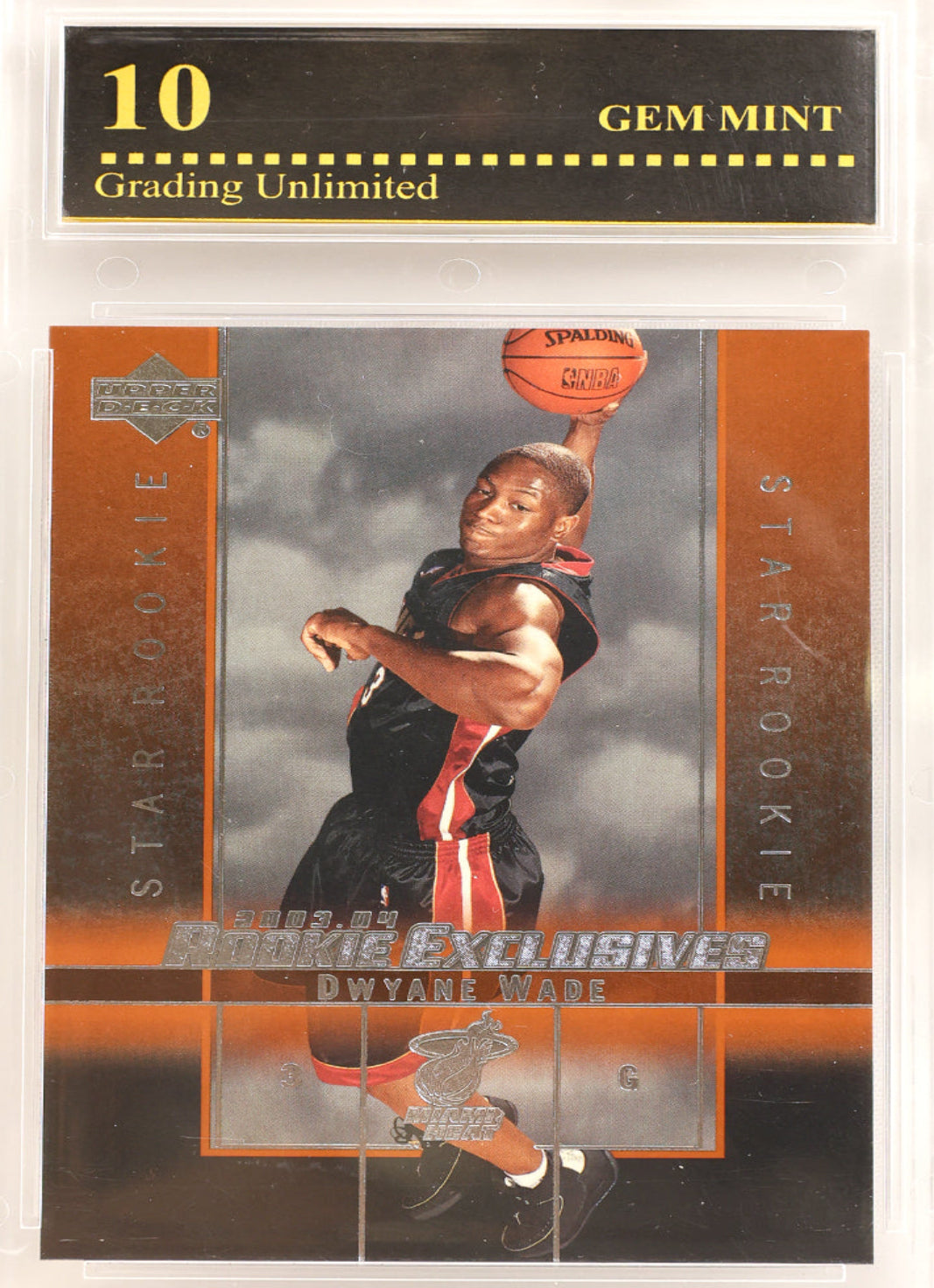 A graded basketball trading card in a clear plastic gem mint holder. The card is for Dwyane Wade, featuring a rookie star photo and a small swatch, with a black and gold PSA-style grading label at the top that reads 10 GEM MINT.