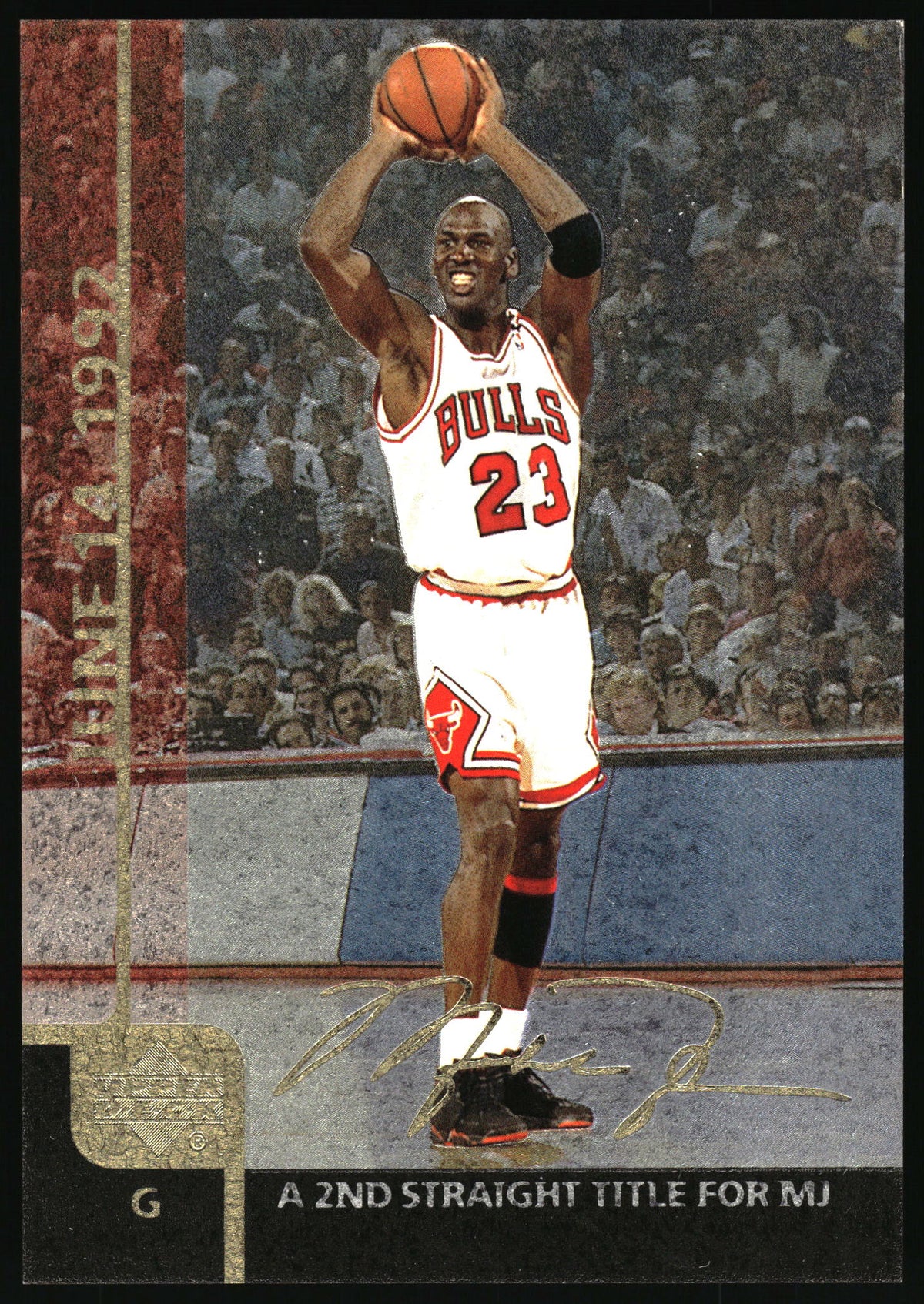 A basketball trading card featuring Michael Jordan in a white Chicago Bulls uniform with the number 23, holding a basketball above his head on a court with a crowd in the background. The card has a textured border on the left reading 'June 14 1992' and text at the bottom reading 'A 2ND STRAIGHT TITLE FOR MJ'.