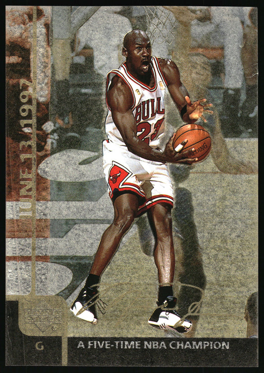 A vintage basketball trading card featuring Michael Jordan in a Chicago Bulls uniform, holding a basketball and wearing black-and-white sneakers. The card includes text reading 'JUNE 13 1997' and 'A FIVE-TIME NBA CHAMPION'.