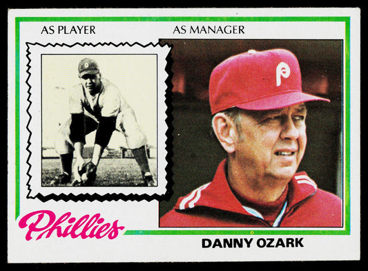 A vintage baseball trading card featuring Danny Ozark, with a black-and-white photo at the top and a color portrait wearing a red Phillies cap at the bottom. The card includes text reading 'Phillies', 'Danny Ozark', and 'As Player' and 'As Manager'.